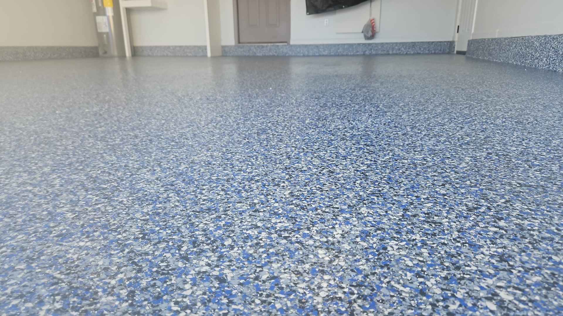 Close-up of blue and gray flake garage floor texture