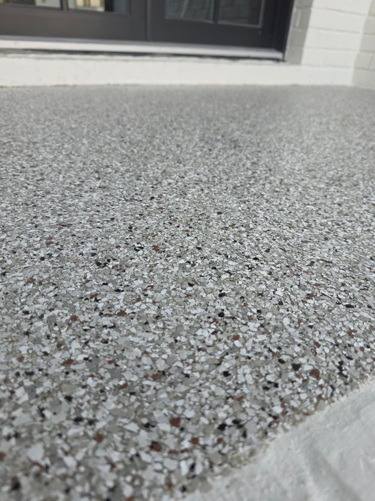 Close-up of flake coating running out to a coated garage apron at the door