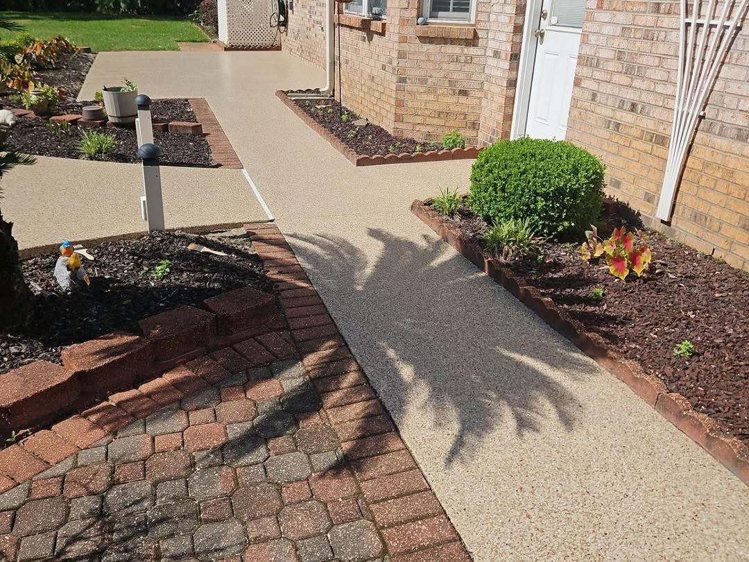 Finished flake-coated walkway with brick edging and garden beds