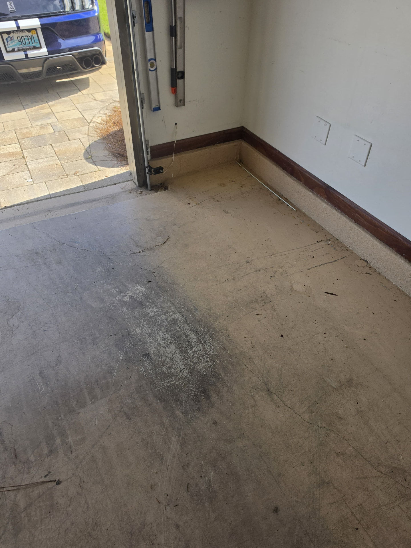 Before: stained and cracked garage concrete