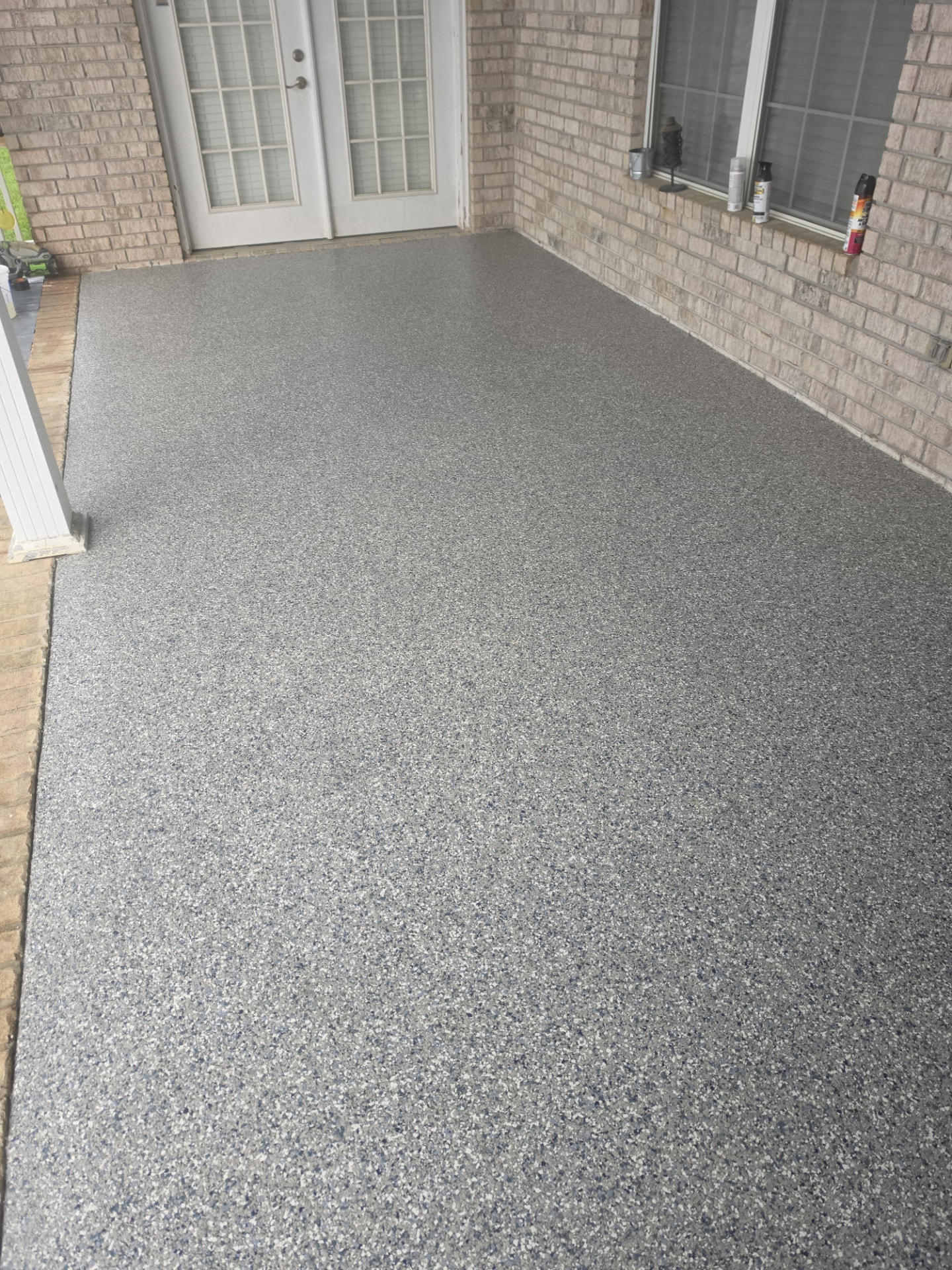 Wide view of a finished flake-coated patio