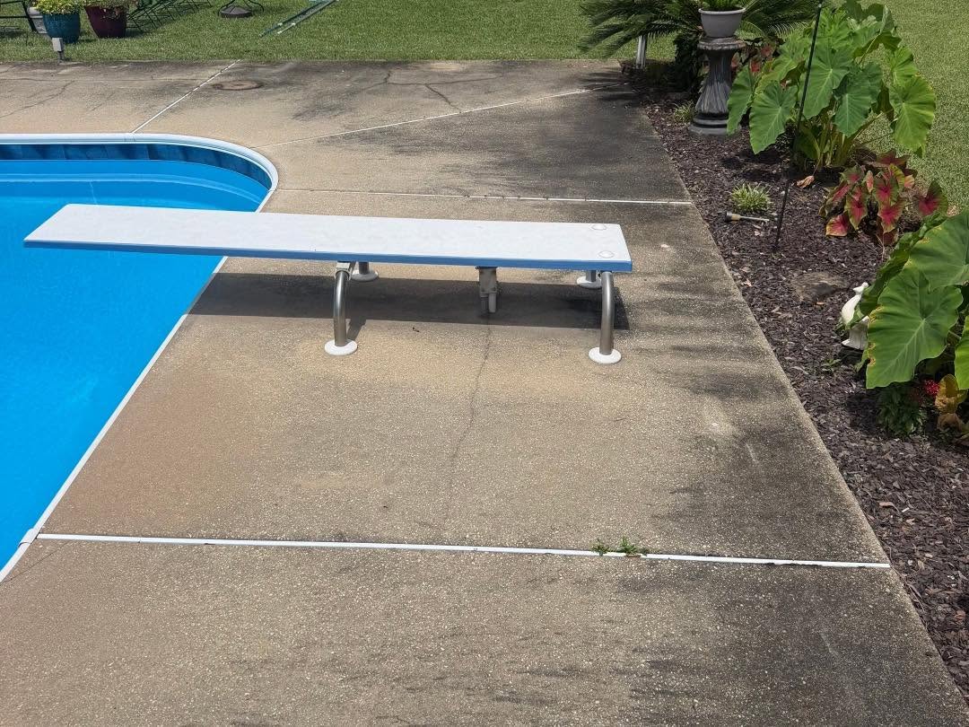 Before: stained concrete pool deck looking toward the backyard