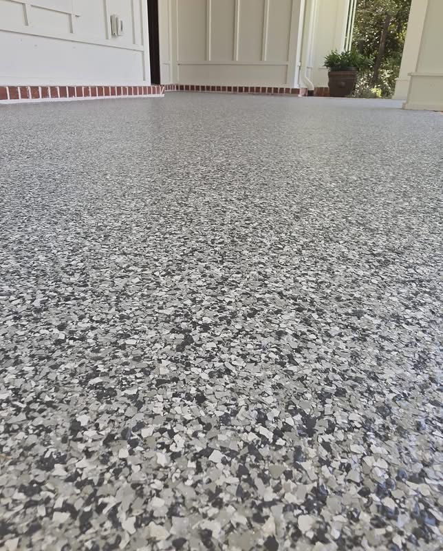 Close-up of gray flake coating on a covered porch floor