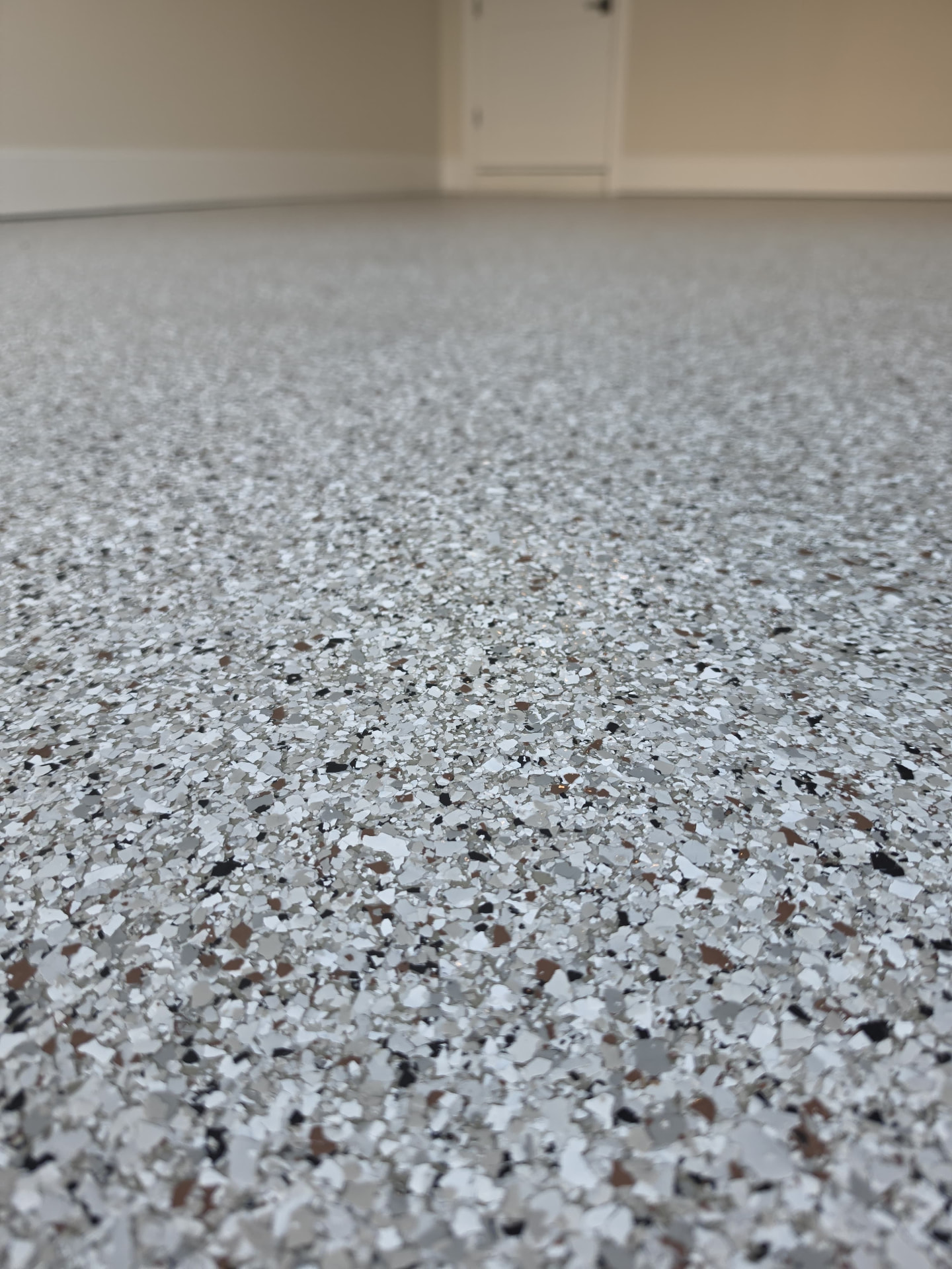 Low angle detail of the finished flake texture across a garage floor