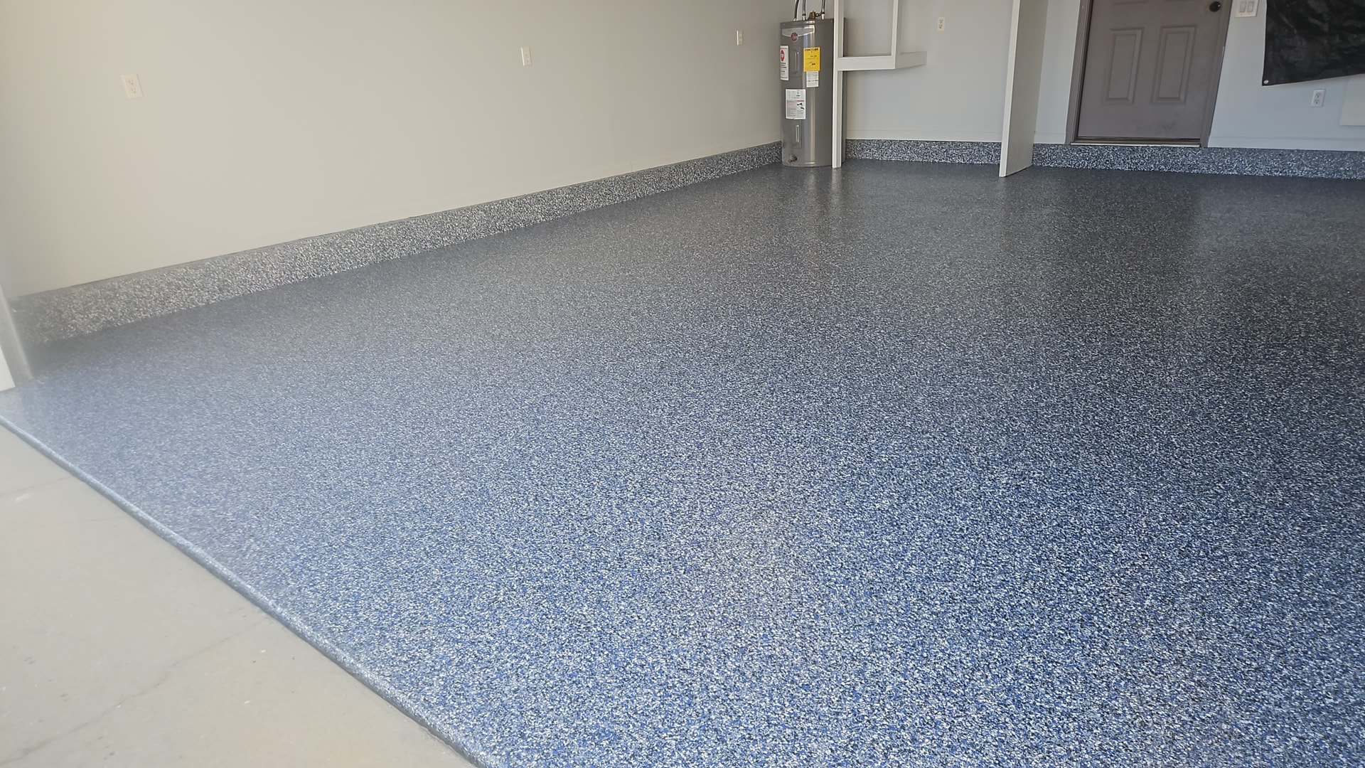 After: blue and gray flake garage floor coating at the entry