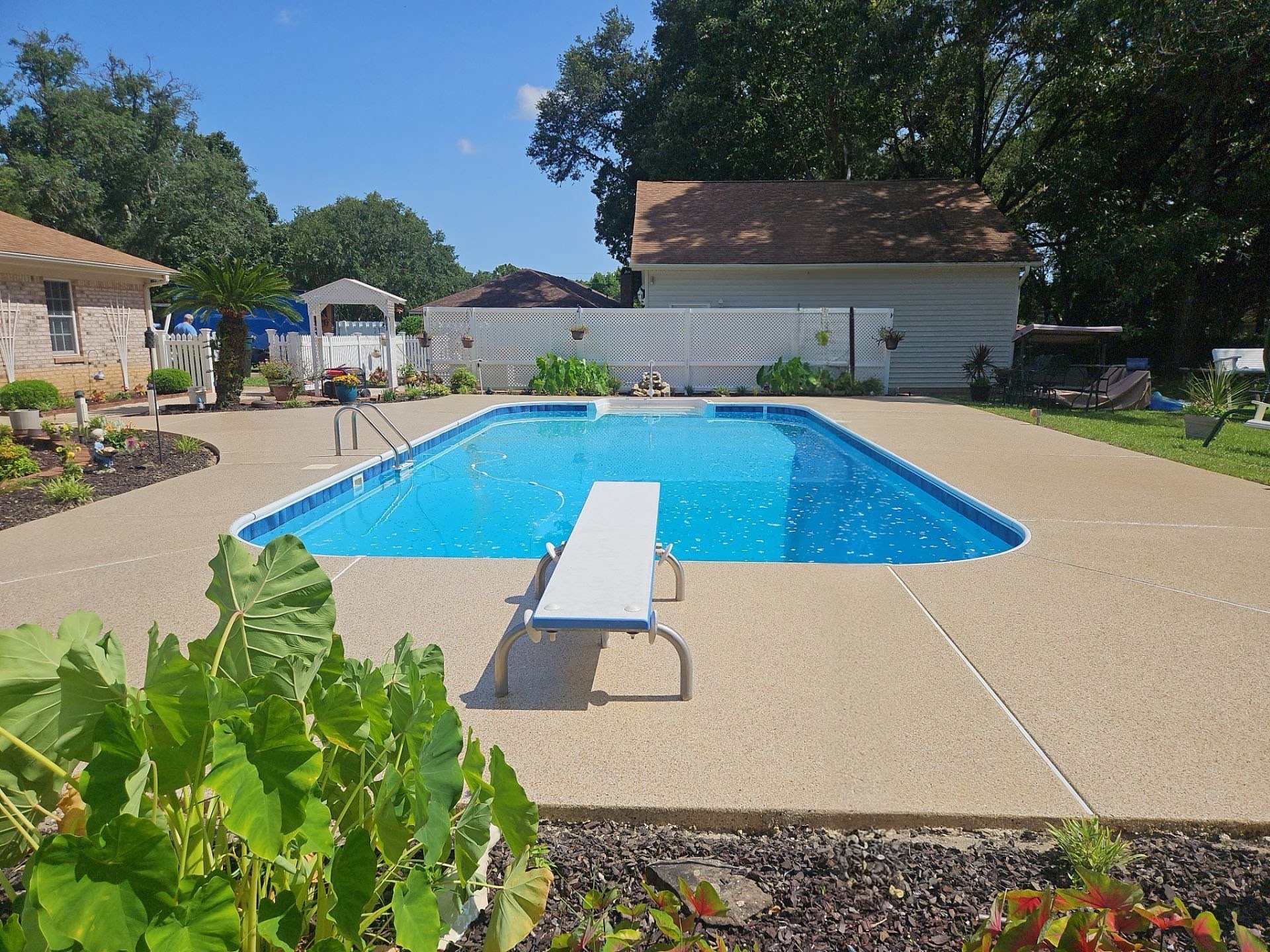 Finished flake-coated pool deck from behind the diving board