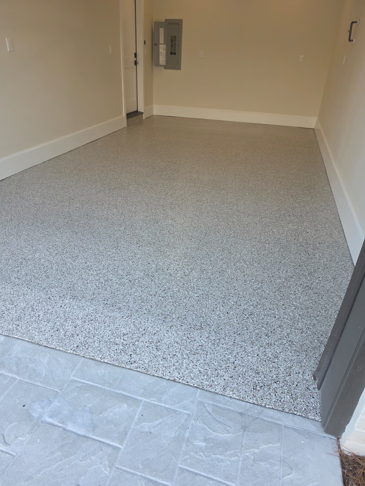 After: gray and white flake coating on the same garage floor