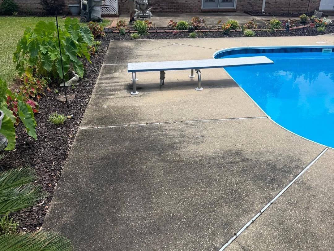 Before: weathered concrete pool deck looking toward the house