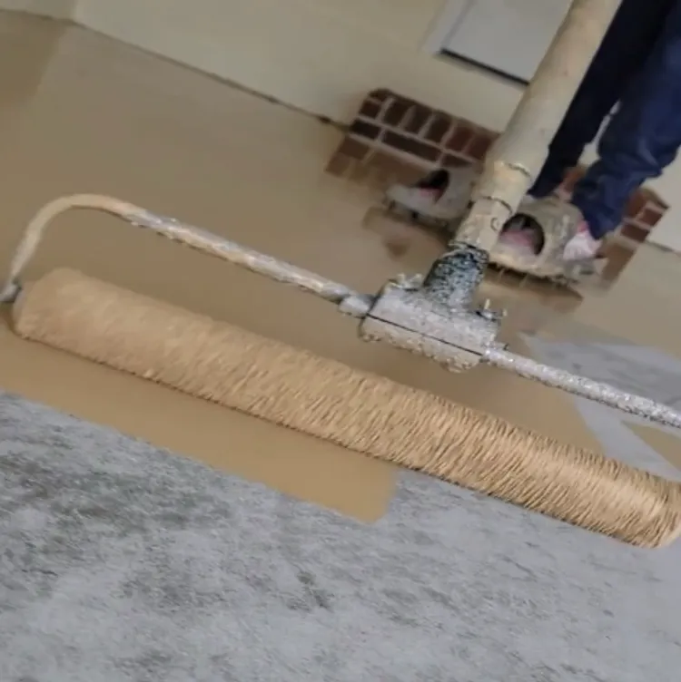 Rolling the polyurea basecoat onto the ground slab