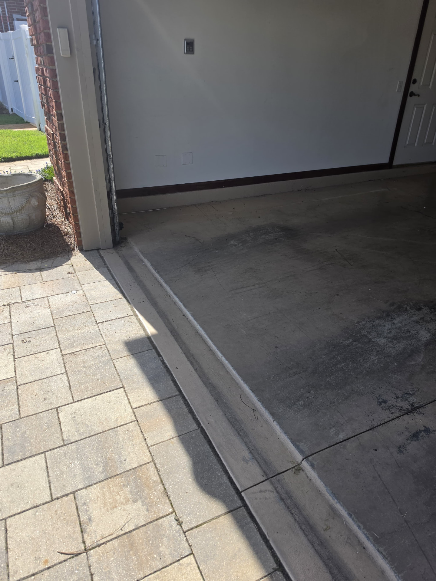 Before: worn garage floor at entry