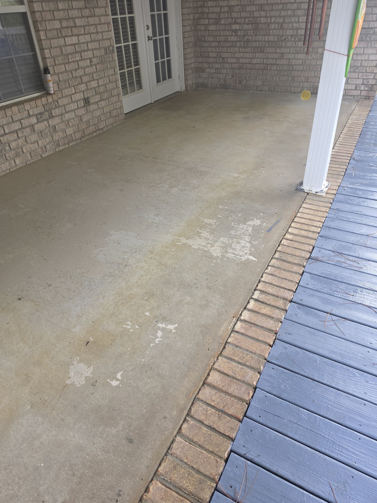 Before: worn and stained back patio concrete
