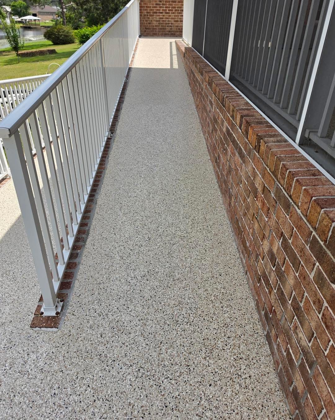 After: tan and black flake coating on the same walkway toward the lake