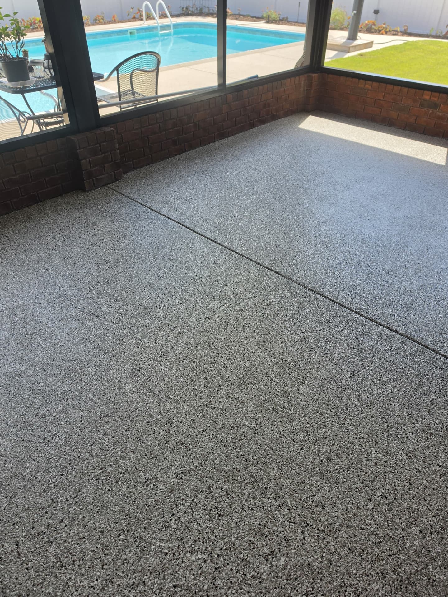 Finished flake coating on a covered patio overlooking the pool