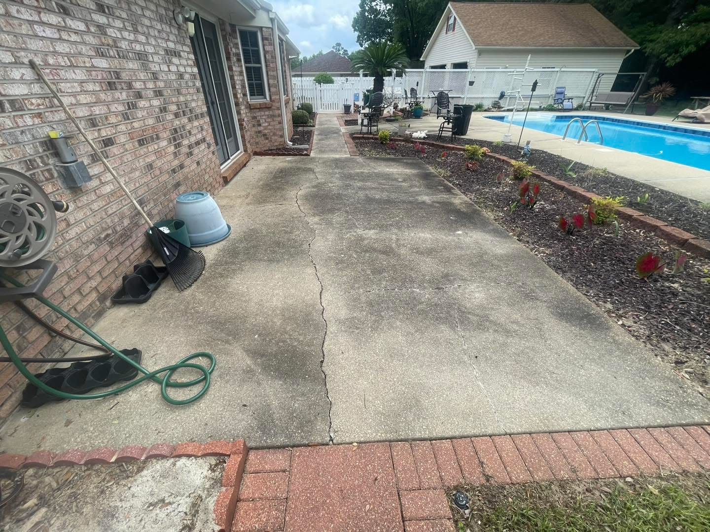Before: cracked and stained patio walkway beside a pool